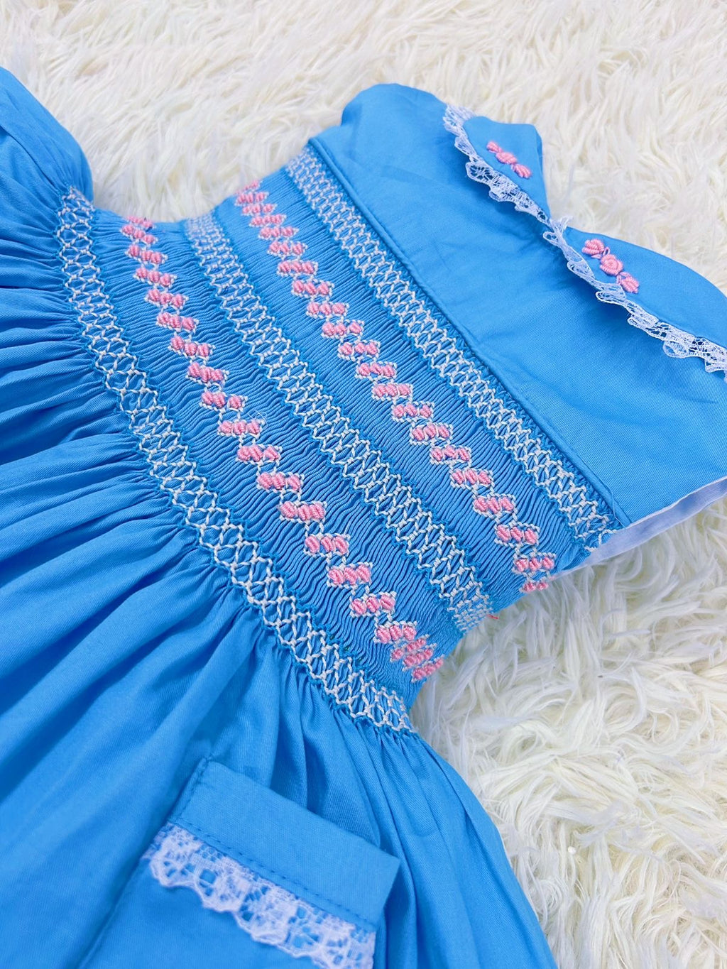 Blue “Francis” Handsmocked sleeveless frock.