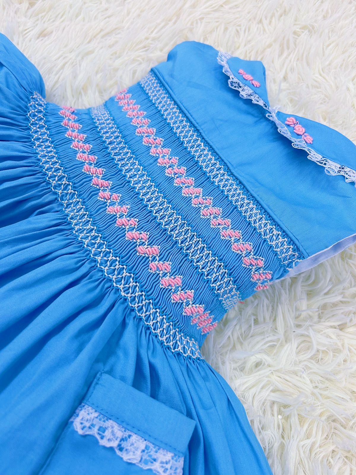 Blue “Francis” Handsmocked sleeveless frock.