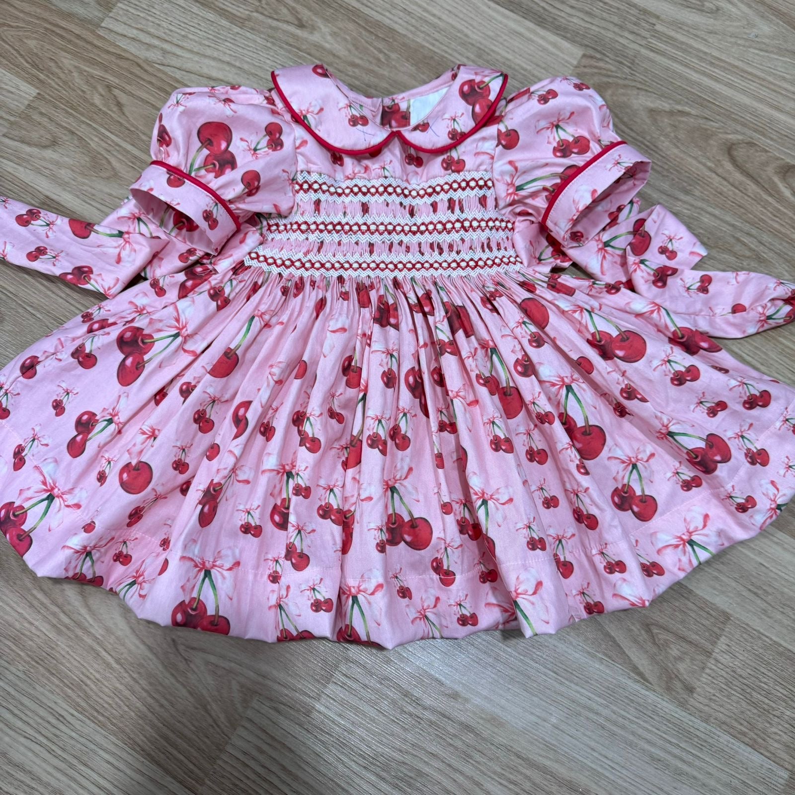 Pink “Cherry Amore” Smocked Dress. Comes with Bows and Bloomers.