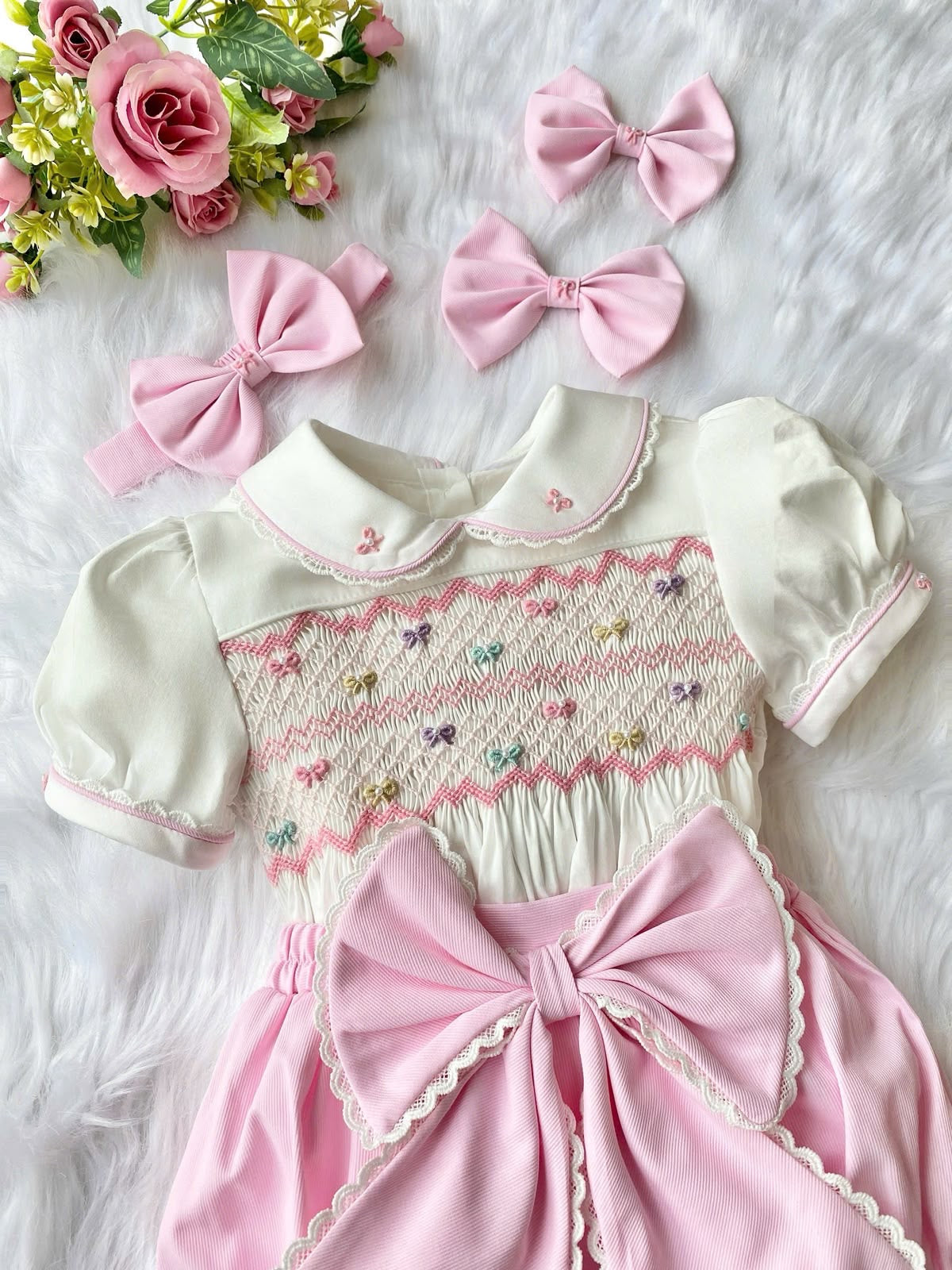 Pink “Beau” handsmocked romper. (Two week pre order)