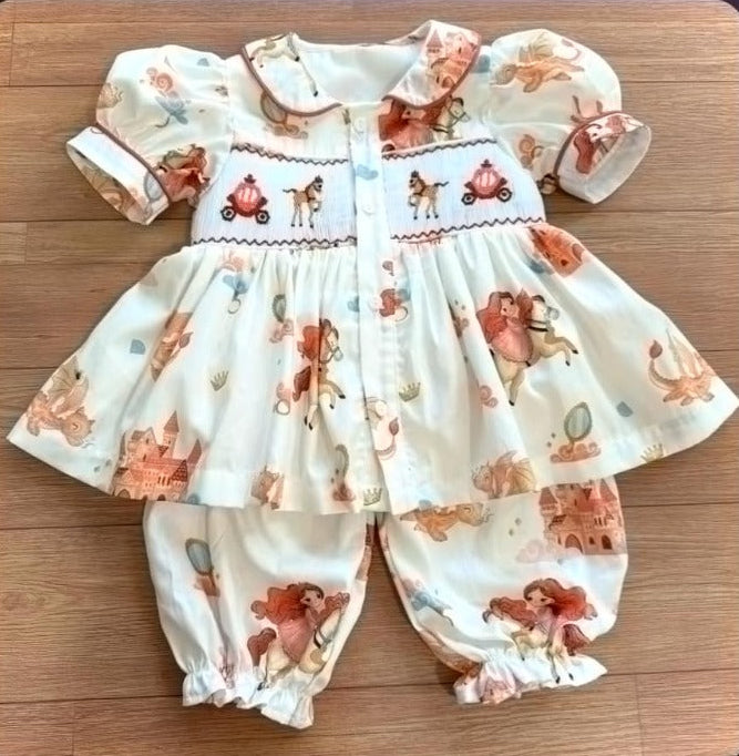 Cream Handsmocked “Fantasy Princess” pyjamas. Comes with two matching bows.