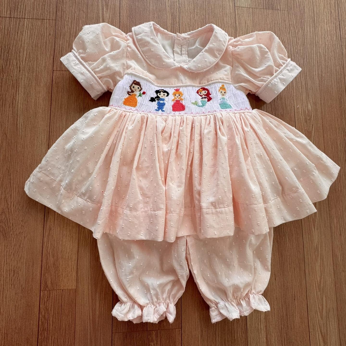 Peach Disney Princess Handsmocked Pyjamas with matching hair bows.