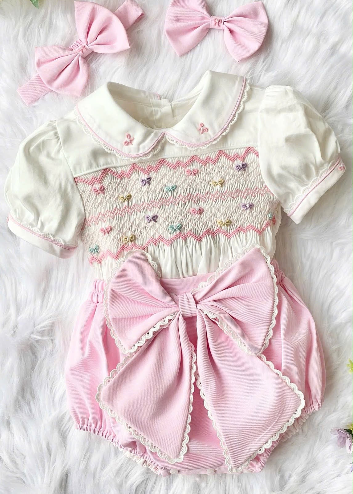 Pink “Beau” handsmocked romper. (Two week pre order)
